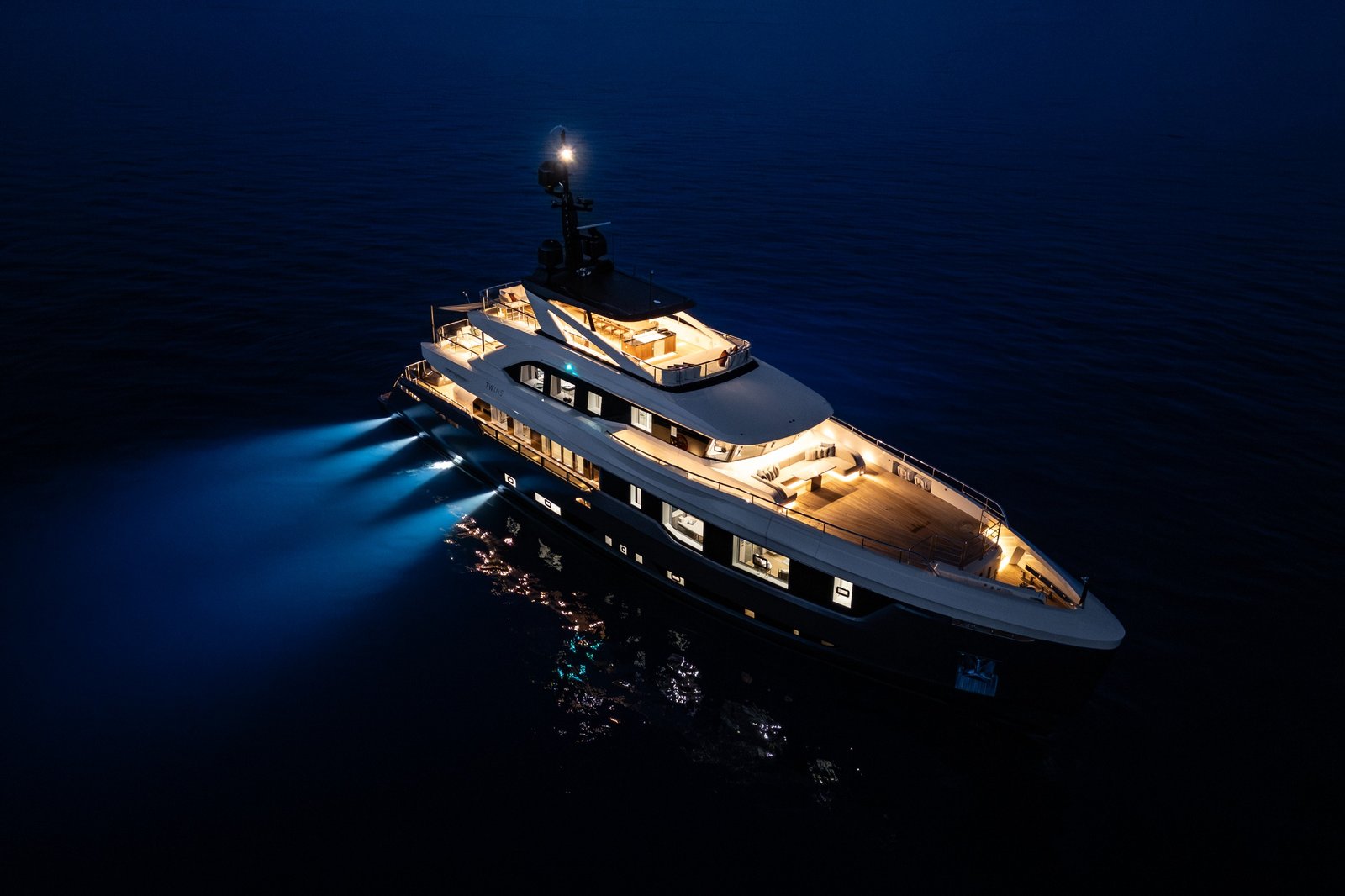 Yachts moored in a marina at dusk